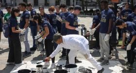 Students gather at a federal park across from the Elliott School of International Affairs on E Street during Saturday's annual Day of Service. (Lily Speredelozz/GW Today)