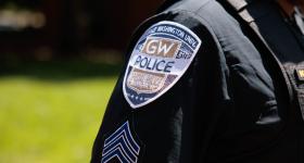 Close-up of a GW Police officer's uniform, showing the department badge and sergeant's chevron on the sleeve